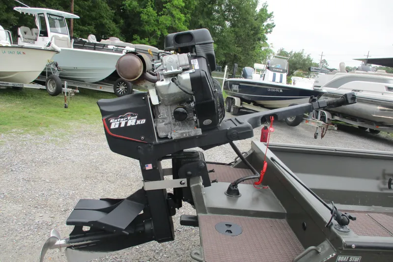 Slide: The Image of 2024 Gator Tail 1848 Gator Series boat motor in a marina setting. - 5