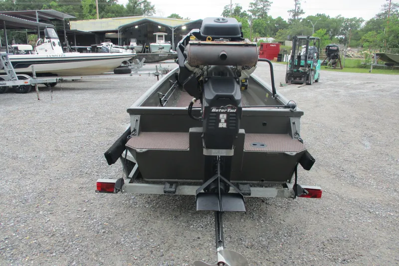 Slide: The Image of 2024 Gator Tail 1848 Gator Series boat with motor, parked on gravel lot. - 6