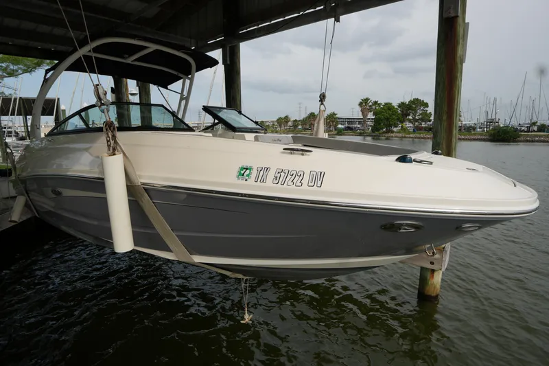 The Image of 2017 Sea Ray 240 Sundeck boat suspended in a marina dock setting. - 0
