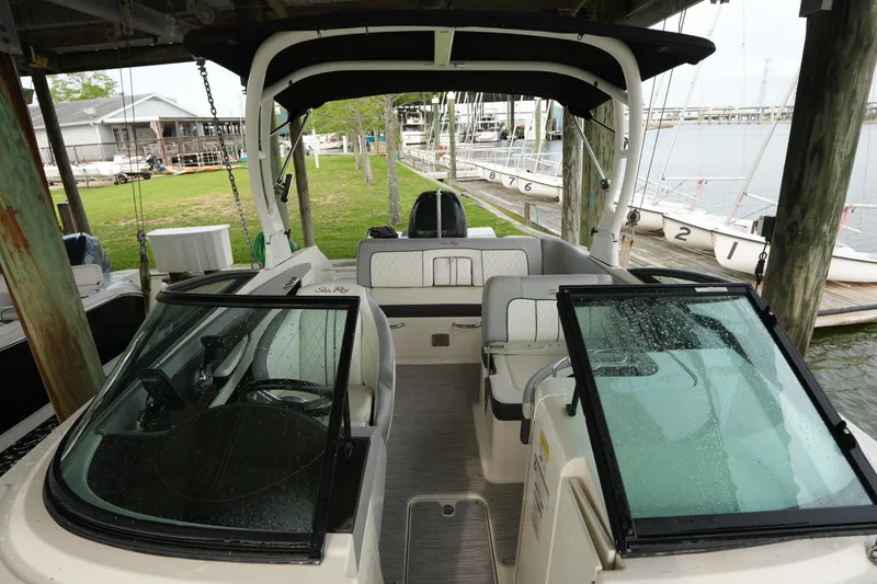 Slide: The Image of 2017 Sea Ray 240 Sundeck boat docked, featuring spacious seating and sleek design. - 2