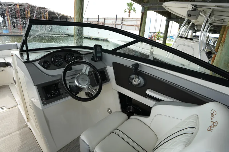Slide: The Image of Interior view of 2017 Sea Ray 240 Sundeck boat cockpit with steering wheel and controls. - 3