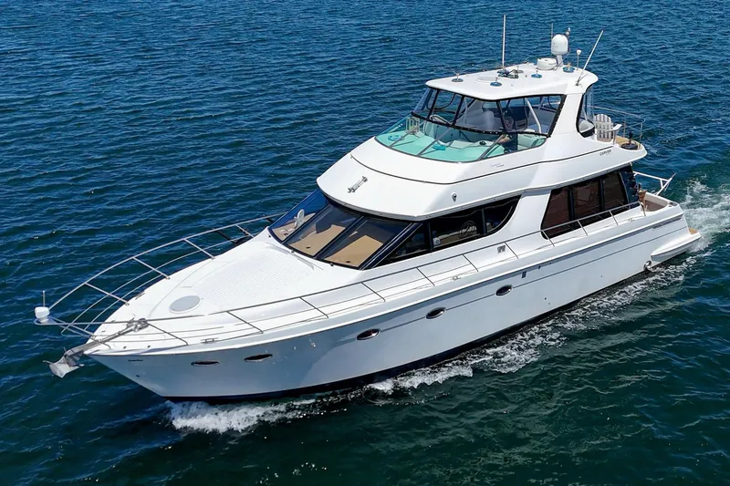Slide: The Image of 2003 Carver 530 Voyager Pilothouse yacht cruising on open water. - 10