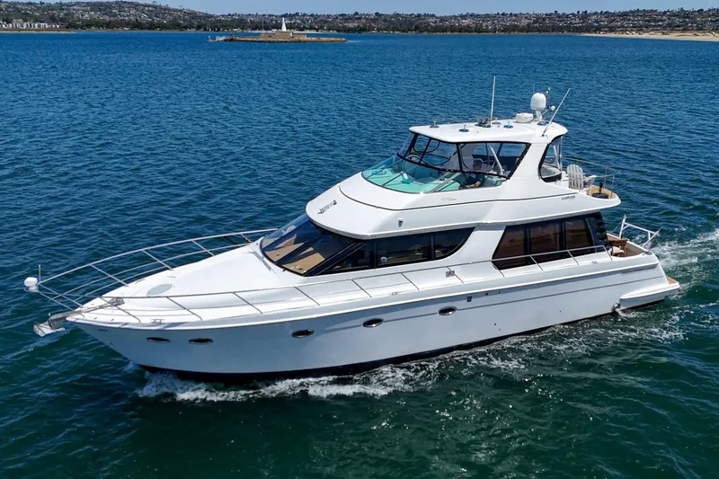 Slide: The Image of 2003 Carver 530 Voyager Pilothouse yacht cruising on blue water. - 11