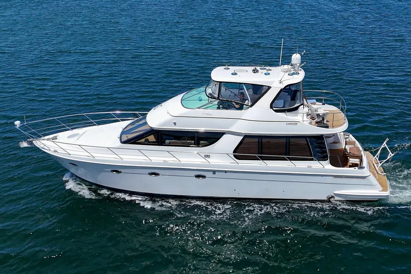 Slide: The Image of 2003 Carver 530 Voyager Pilothouse yacht cruising on open water. - 12