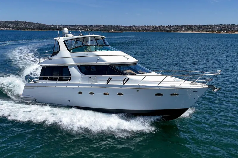 Slide: The Image of 2003 Carver 530 Voyager Pilothouse yacht cruising on open water. - 13