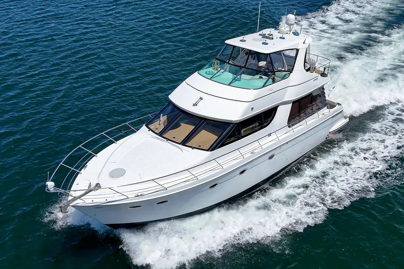 Slide: The Image of 2003 Carver 530 Voyager Pilothouse yacht cruising on open water. - 14