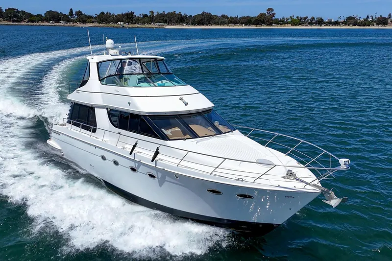 Slide: The Image of 2003 Carver 530 Voyager Pilothouse cruising on open water, showcasing sleek design and luxury. - 15