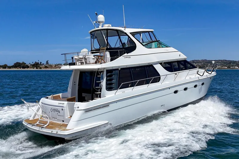Slide: The Image of 2003 Carver 530 Voyager Pilothouse yacht cruising on open water. - 16