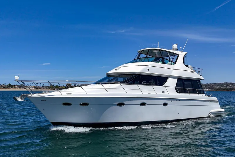 Slide: The Image of 2003 Carver 530 Voyager Pilothouse yacht cruising on open water. - 17