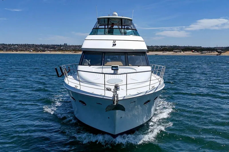 Slide: The Image of 2003 Carver 530 Voyager Pilothouse yacht cruising on open water under clear skies. - 18