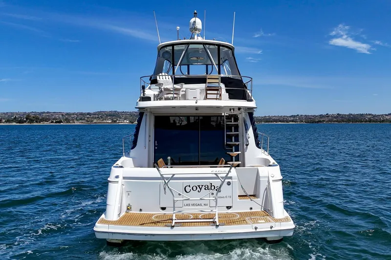 Slide: The Image of 2003 Carver 530 Voyager Pilothouse yacht cruising on open water under clear skies. - 20