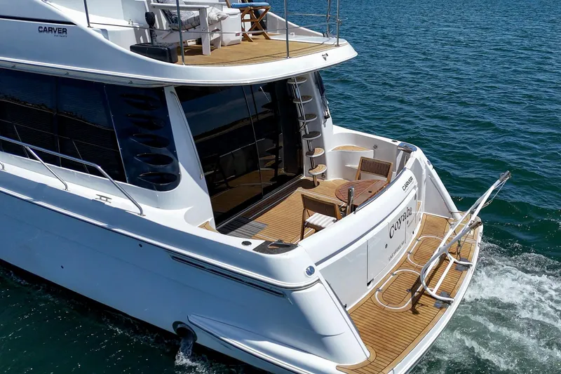 Slide: The Image of 2003 Carver 530 Voyager Pilothouse yacht cruising on open water. - 22