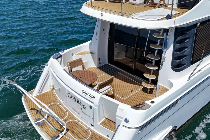 Slide: The Image of 2003 Carver 530 Voyager Pilothouse yacht with elegant deck and spiral staircase on the water. - 24