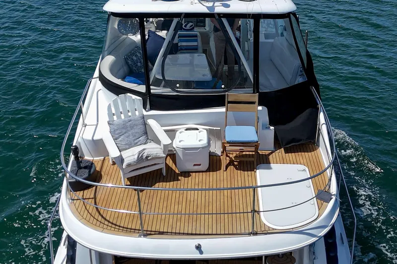 Slide: The Image of 2003 Carver 530 Voyager Pilothouse yacht with spacious deck and seating on open water. - 27