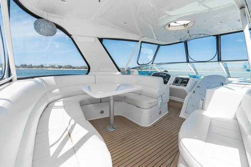 Slide: The Image of Luxurious interior of 2003 Carver 530 Voyager Pilothouse with white seating and panoramic windows. - 32