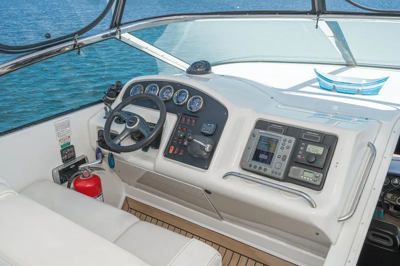 Slide: The Image of 2003 Carver 530 Voyager Pilothouse helm with navigation controls and ocean view. - 33