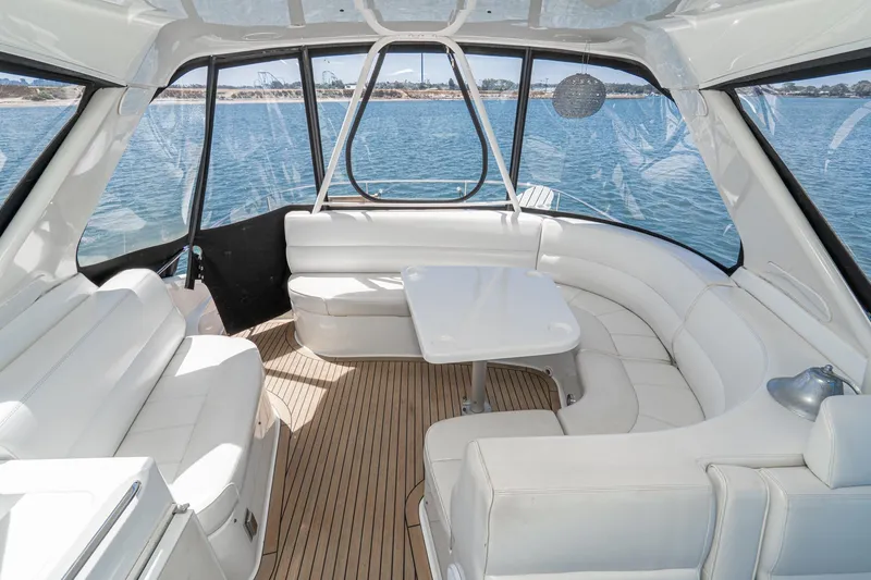 Slide: The Image of Luxurious interior of 2003 Carver 530 Voyager Pilothouse with white seating and scenic water view. - 34