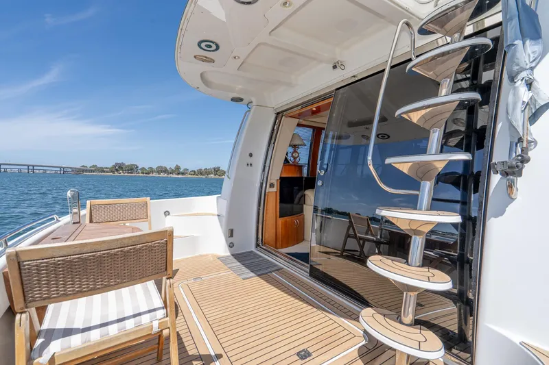 Slide: The Image of 2003 Carver 530 Voyager Pilothouse yacht deck with spiral staircase and ocean view. - 36