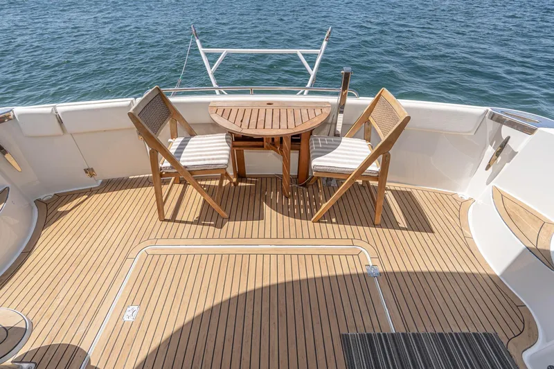 Slide: The Image of Deck of 2003 Carver 530 Voyager Pilothouse with chairs and table, overlooking water. - 37