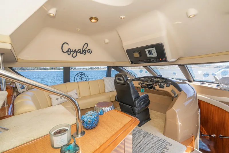 Slide: The Image of Luxurious 2003 Carver 530 Voyager Pilothouse interior with helm, leather seating, and scenic water view. - 41