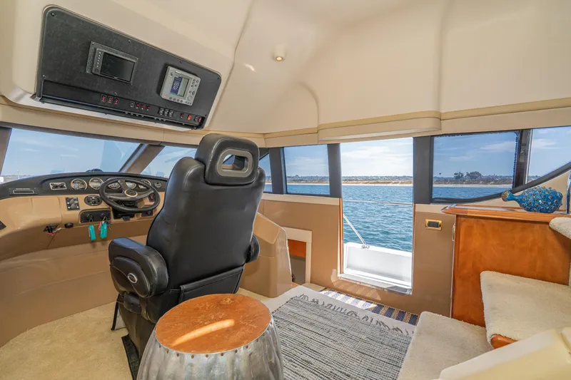 Slide: The Image of Pilothouse interior of 2003 Carver 530 Voyager, featuring helm and ocean view. - 42