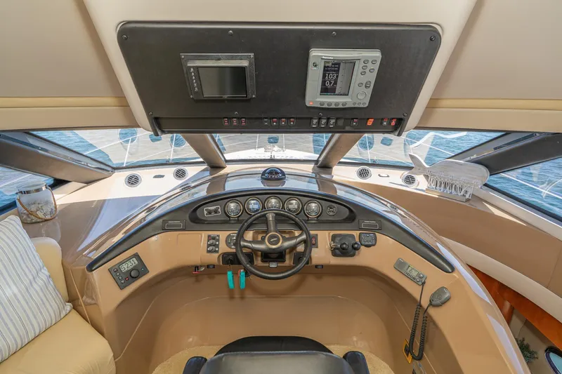Slide: The Image of Pilothouse interior of 2003 Carver 530 Voyager, featuring steering wheel and navigation instruments. - 43