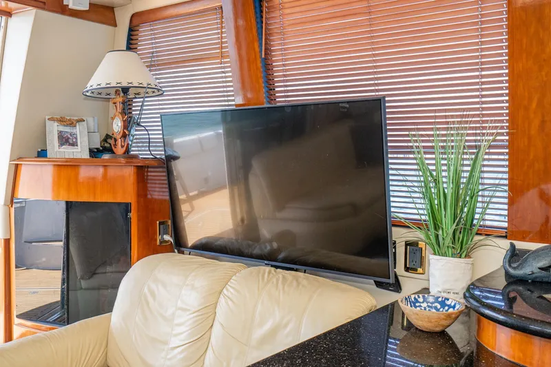 Slide: The Image of Luxurious interior of 2003 Carver 530 Voyager Pilothouse with TV, lamp, and decor. - 51