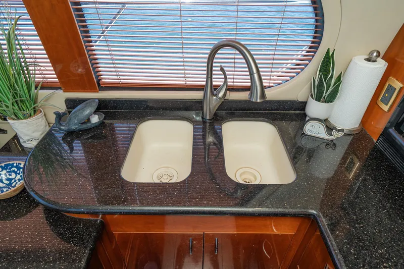 Slide: The Image of Luxurious kitchen sink area on 2003 Carver 530 Voyager Pilothouse yacht with elegant fixtures. - 56