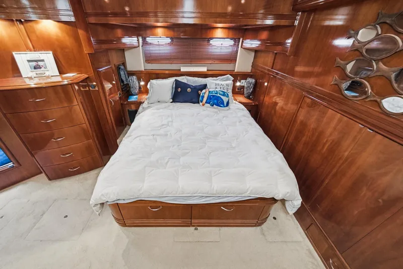 Slide: The Image of Luxurious 2003 Carver 530 Voyager Pilothouse bedroom with elegant wood finish and cozy bedding. - 59