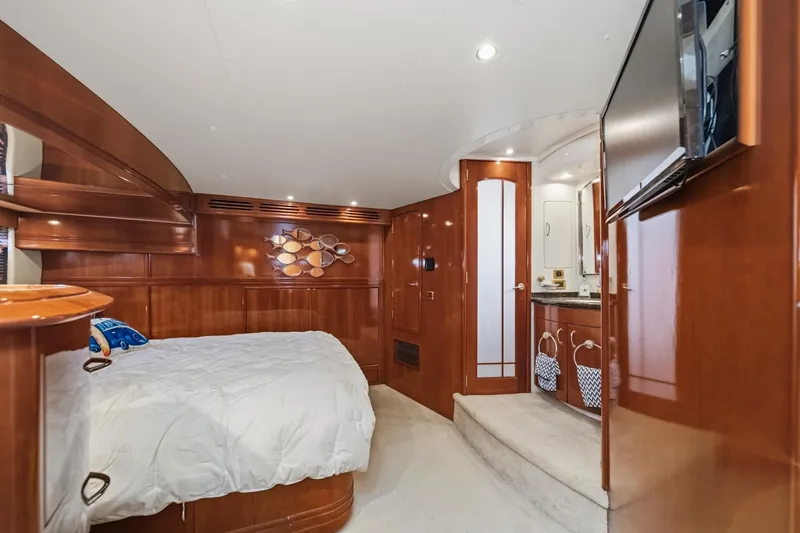 Slide: The Image of Luxurious interior of 2003 Carver 530 Voyager Pilothouse yacht bedroom with wood paneling. - 60