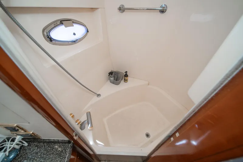 Slide: The Image of Shower area in 2003 Carver 530 Voyager Pilothouse yacht with porthole and fixtures. - 65