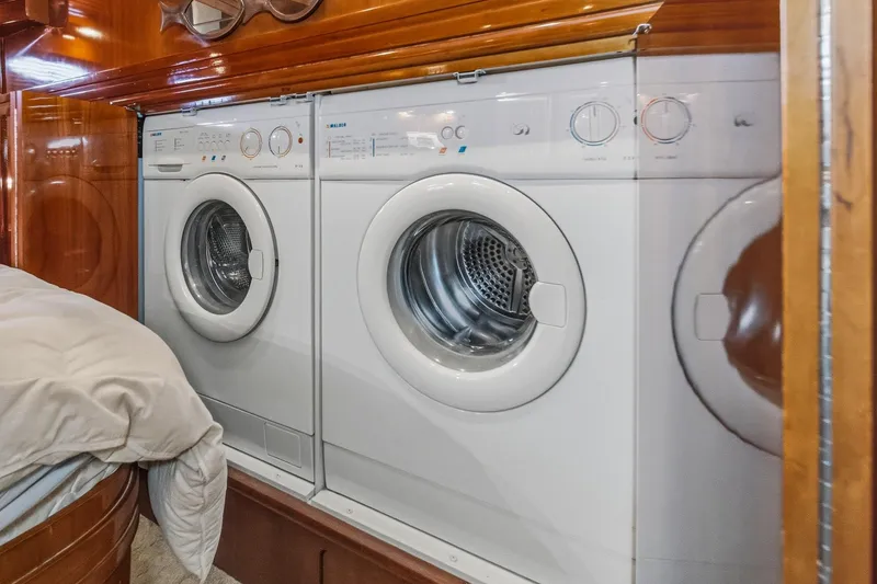 Slide: The Image of Laundry area inside 2003 Carver 530 Voyager Pilothouse yacht with washer and dryer. - 66