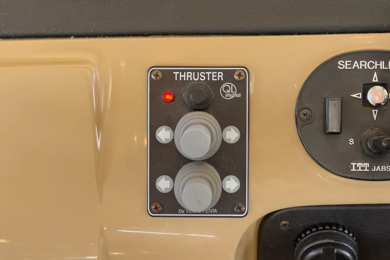 Slide: The Image of Control panel of a 2003 Carver 530 Voyager Pilothouse with thruster and searchlight switches. - 74