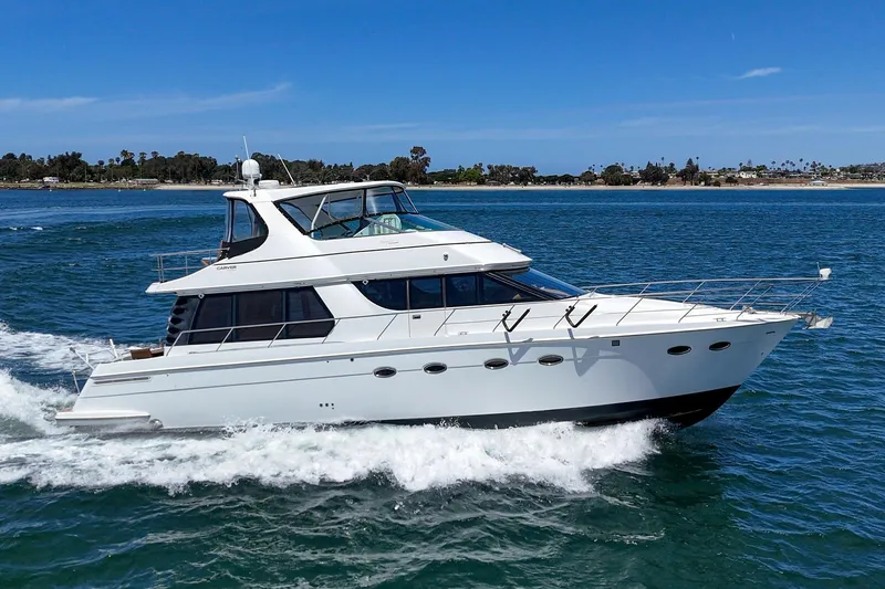 Slide: The Image of 2003 Carver 530 Voyager Pilothouse yacht cruising on blue ocean waters. - 8