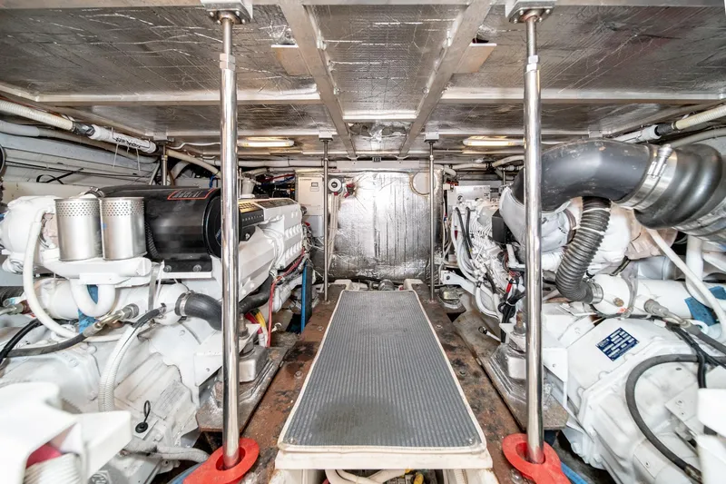 Slide: The Image of Engine room of a 2003 Carver 530 Voyager Pilothouse, showcasing dual engines and mechanical components. - 80