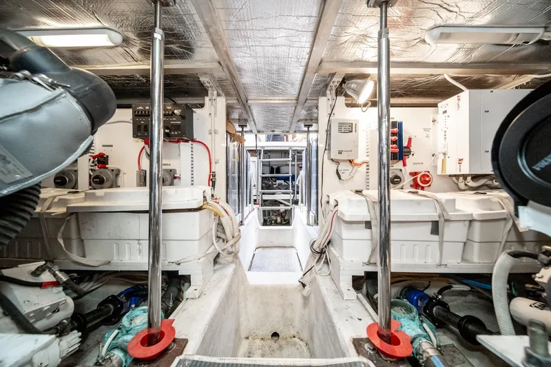 Slide: The Image of Engine room of 2003 Carver 530 Voyager Pilothouse, showcasing mechanical components and equipment. - 83