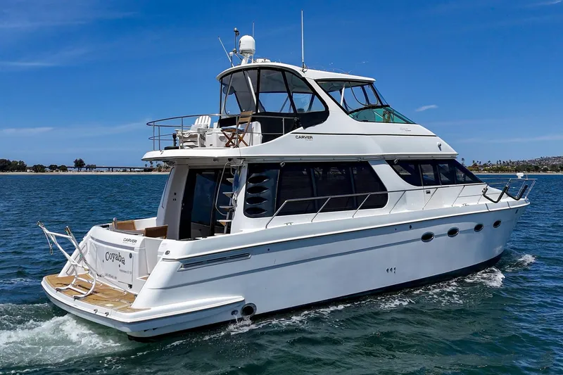 Slide: The Image of 2003 Carver 530 Voyager Pilothouse yacht cruising on a sunny day. - 9