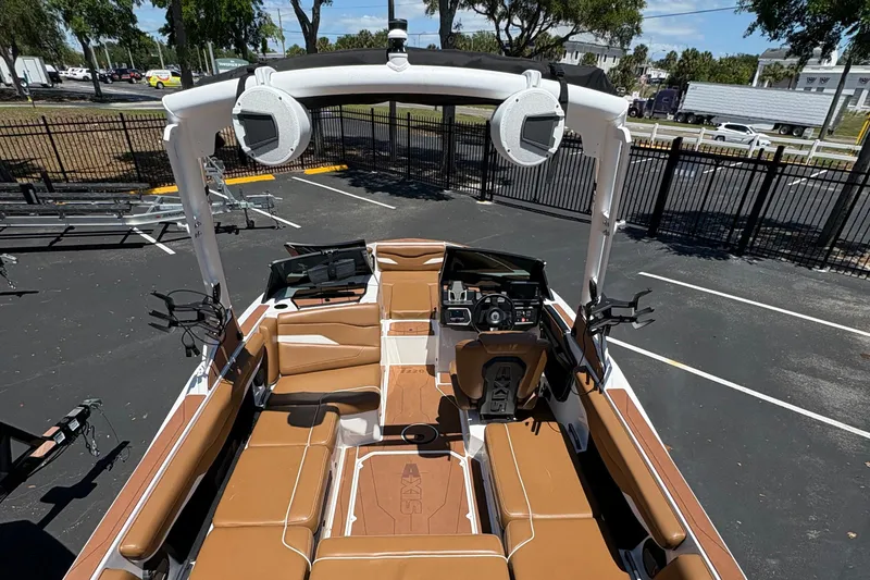Slide: The Image of 2025 Axis T220 boat interior with brown seating and advanced dashboard features. - 6