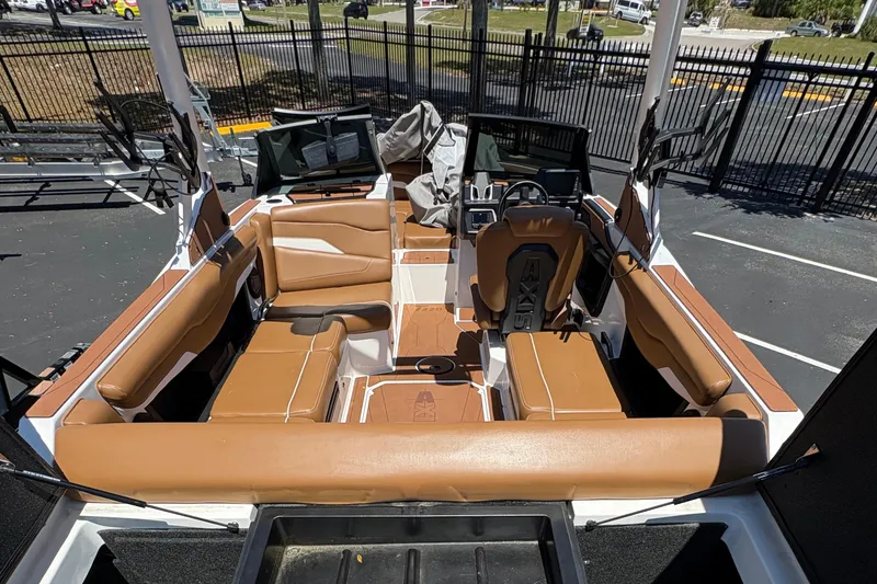 Slide: The Image of 2025 Axis T220 boat interior with tan seating and modern dashboard design. - 7