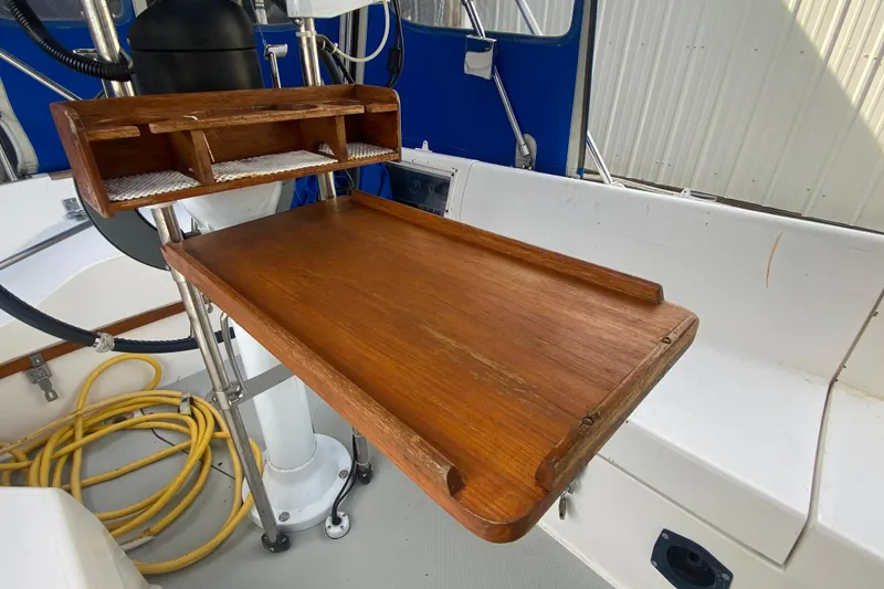 Slide: The Image of Wooden cockpit table on a 1987 Catalina 30 MkII sailboat, with storage compartments. - 10