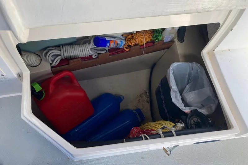 Slide: The Image of Storage compartment of a 1987 Catalina 30 MkII sailboat with ropes, fuel can, and fenders. - 16