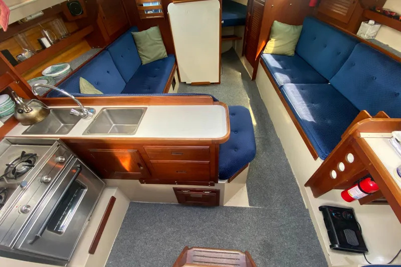 Slide: The Image of Interior of a 1987 Catalina 30 MkII sailboat with kitchen and seating area. - 18