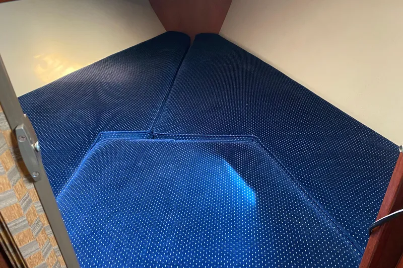 Slide: The Image of Interior cabin view of a 1987 Catalina 30 MkII sailboat with blue polka dot cushions. - 26