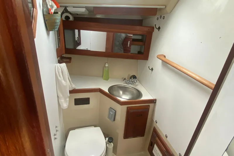 Slide: The Image of Compact bathroom in a 1987 Catalina 30 MkII sailboat with sink and toilet. - 28