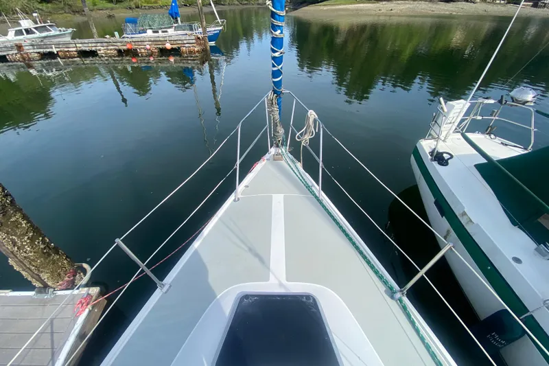 Slide: The Image of Bow view of 1987 Catalina 30 MkII sailboat docked in calm marina waters. - 3
