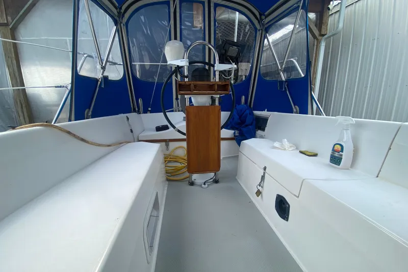 Slide: The Image of Interior view of a 1987 Catalina 30 MkII sailboat cockpit with blue canopy. - 7