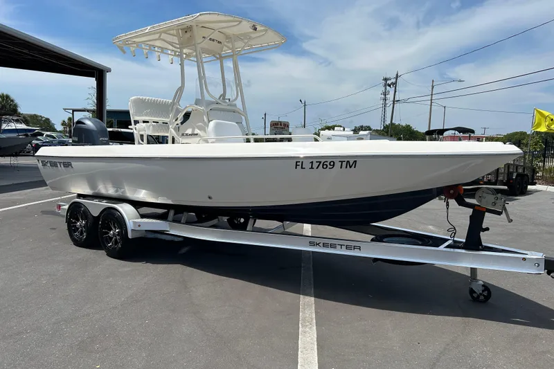The Image of 2022 Skeeter SX2250 boat on trailer in parking lot, side view. - 1