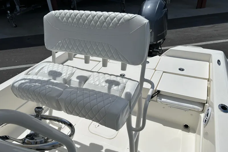 Slide: The Image of 2022 Skeeter SX2250 boat with white quilted seating and steering wheel. - 12