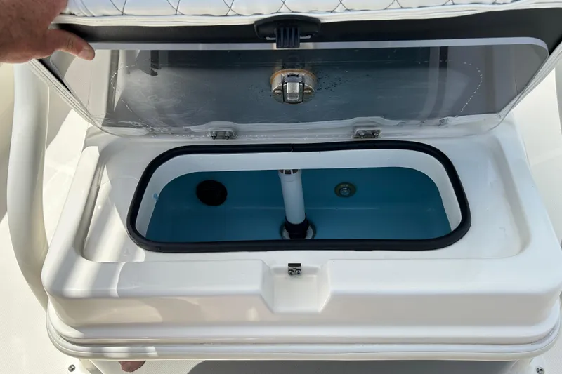 Slide: The Image of Livewell compartment in a 2022 Skeeter SX2250 boat, open lid showing interior. - 15
