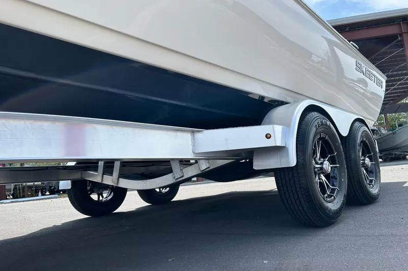 Slide: The Image of 2022 Skeeter SX2250 boat on trailer, showcasing sleek design and dual wheels. - 17